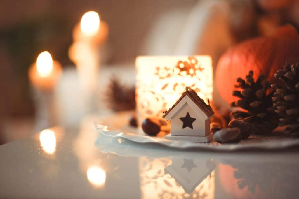 Candle light with a holiday centerpiece. Exhale, breathe deep, a time of celebration.
