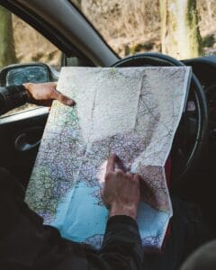 person holding map in vehicle